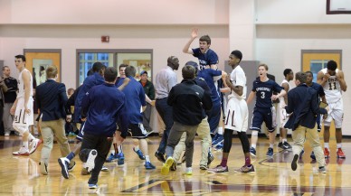 Conner Delaney, center, being hoisted by his Episcopal Academy teammates after his game-winning 3-pointer against Haverford School last week, has powered the Churchmen to the top of the Inter-Ac ... and up this week's rankings. (Times Staff/TOM KELLY IV)